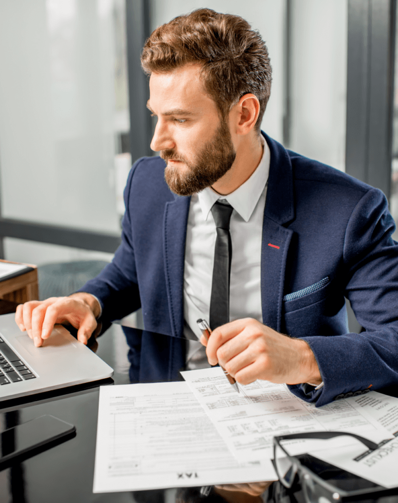 Tax manager working at a laptop in the office