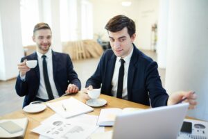 Two businessmen discussing financial information