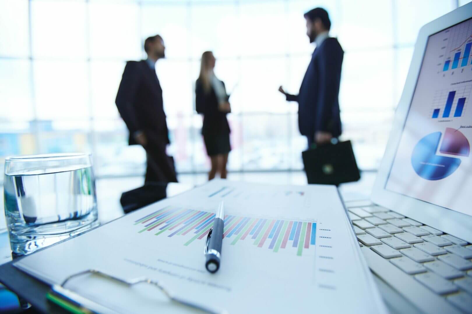 Business people meeting by a desk with financial reports